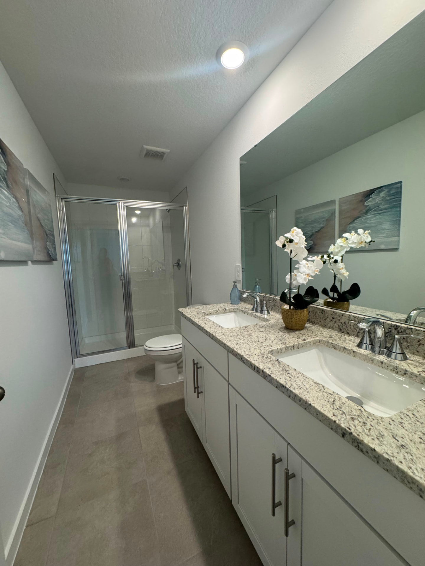 Double-vanity bathroom with granite counters and walk-in shower